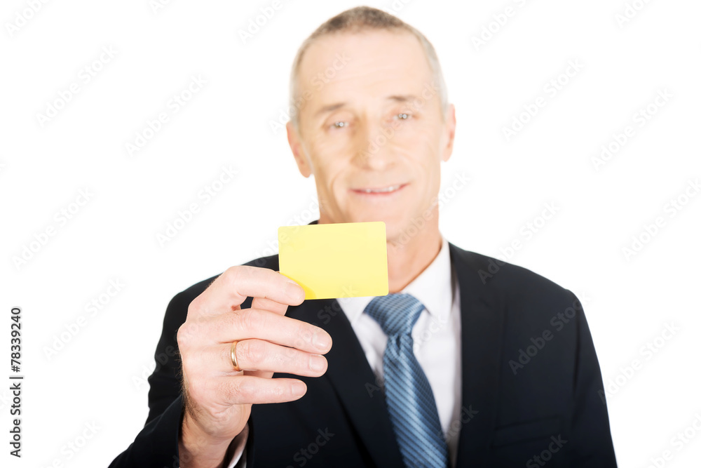 Businessman showing a yellow identity name card Businessman showing a yellow identity name card