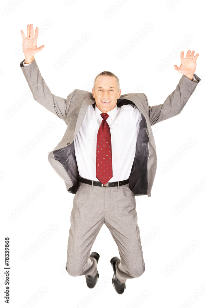 Excited businessman jumping because of success Excited businessman jumping because of success