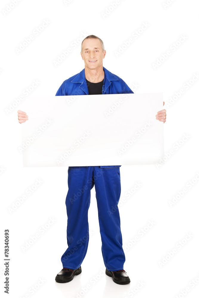 Happy worker presenting empty banner Happy worker presenting empty banner