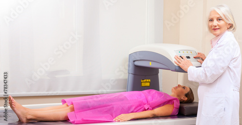 Принти на полотні Female patient undergoing x-ray scan with professional assistanc
