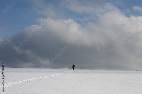 Man on ski track against cloudy sky © patrikslezak