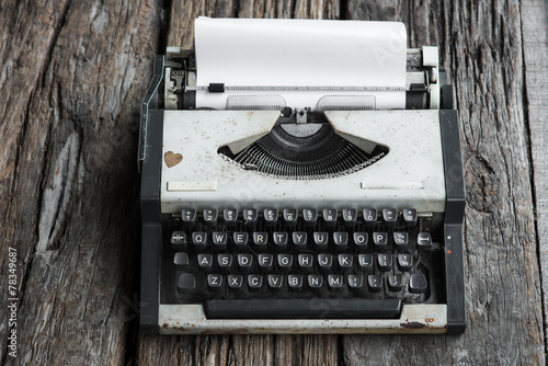 vintage typewriter and telephone , notebook on the wood desk