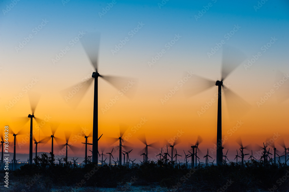 Obraz premium Wind Turbines in desert during sunrise time