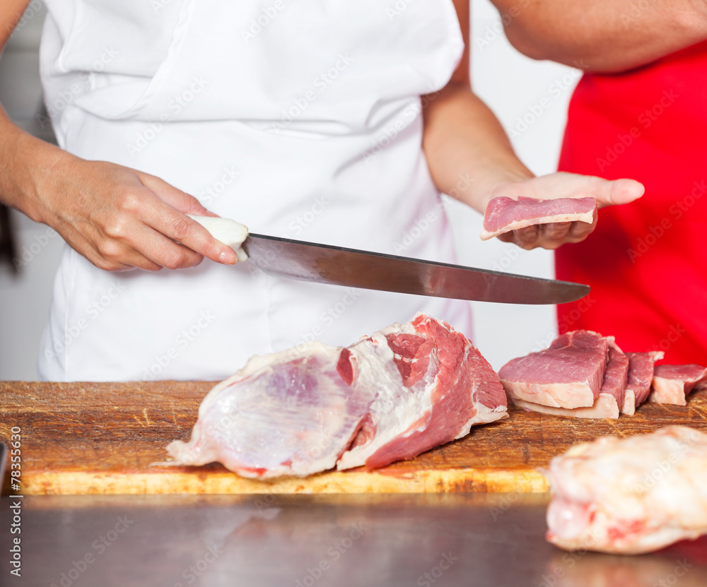 Butcher Holding Knife And Fresh Meat Piece