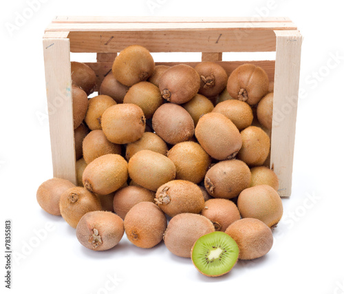 Spilled kiwifruits in wooden crate