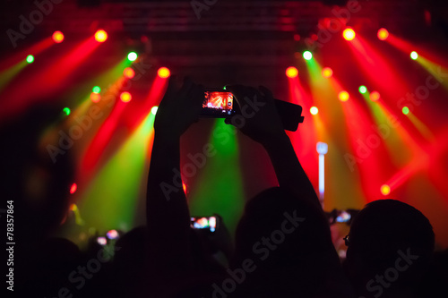 People at concert shooting video or photo.