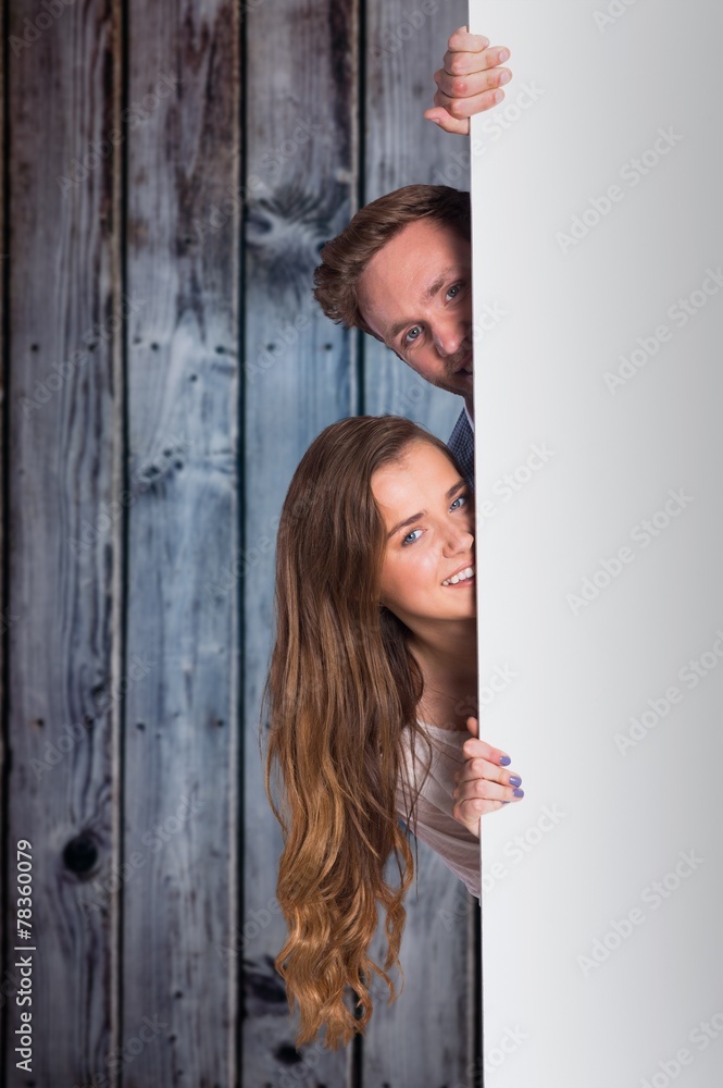 Composite image of portrait of young couple with blank board Composite image of portrait of young couple with blank board
