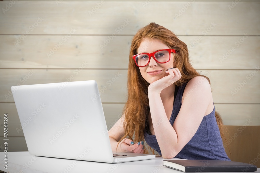 Composite image of pretty redhead working on laptop Composite image of pretty redhead working on laptop