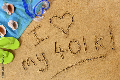 The words I love my 401k written in sand on a beach with towel flip flops and seashells old age summer holiday vacation photo