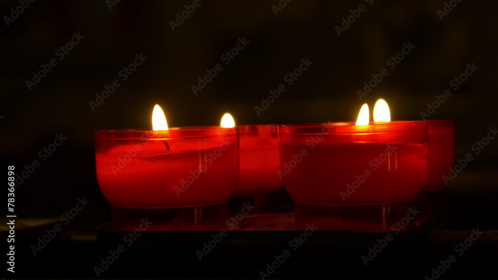 Little red candles in a church Stock Video Adobe Stock