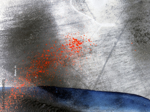 Small part of grey metal wall with  blue and red paint
