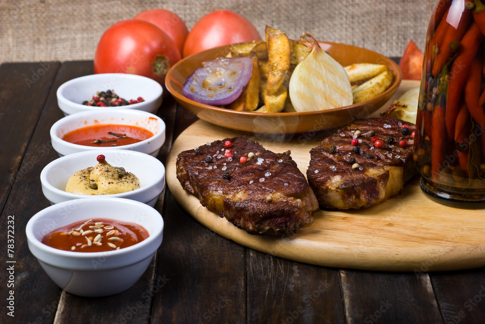 Beef Steaks with Sauces, French Fries and Vegetables Beef Steaks with Sauces, French Fries and Vegetables