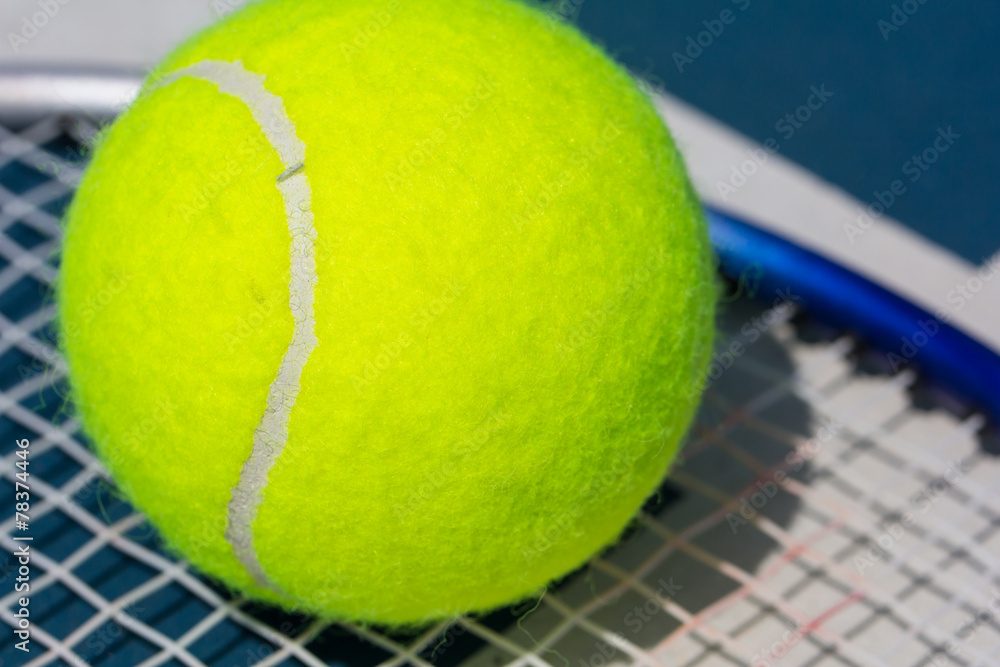 Close up of a tennis ball on racket
