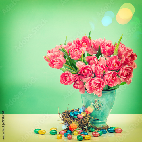 Tulip flowers and chocolate easter eggs. Vintage style toned pic