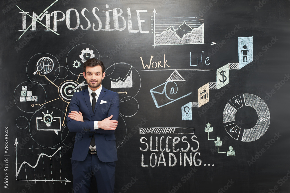 Smiling businessman and chalkboard with colorful graphs on it Smiling businessman and chalkboard with colorful graphs on it