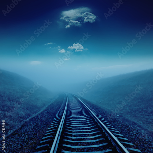 railroad in night under blue moonlight.