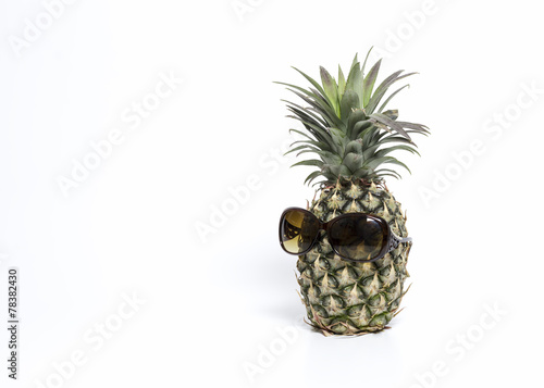 Pineapple wearing sunglasses isolated with white background