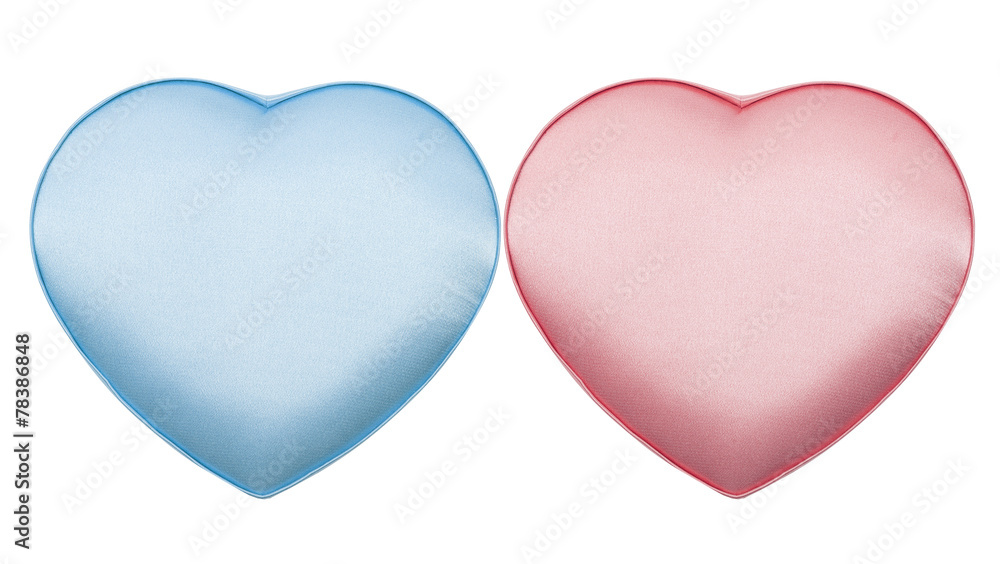 Couple of silk boxes in form of heart, pink and blue, isolated