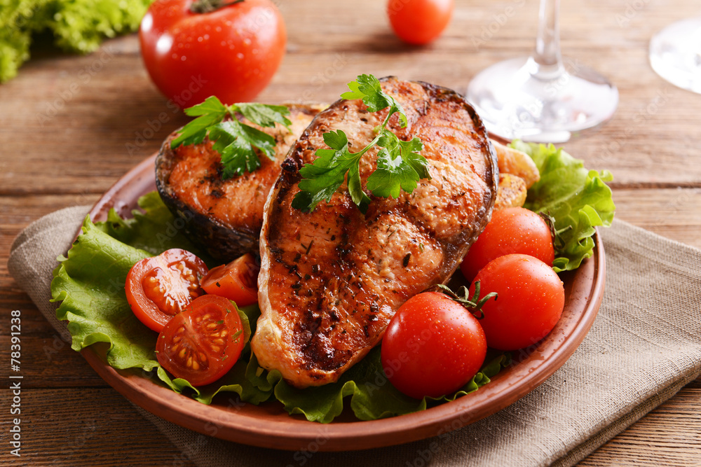 Tasty baked fish on plate on table close-up