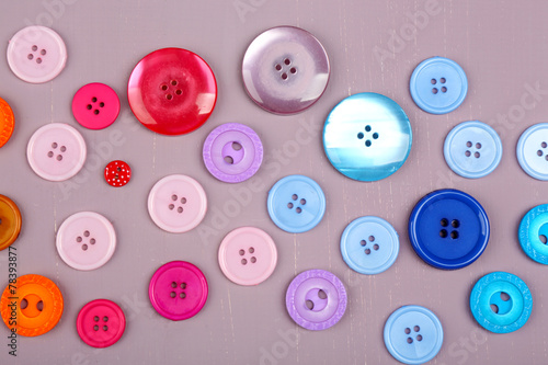 Colorful buttons on wooden background