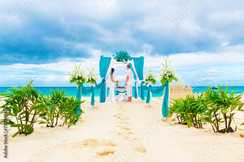 Fototapeta Naklejka Na Ścianę i Meble -  Wedding ceremony on a tropical beach in blue. Happy groom and br