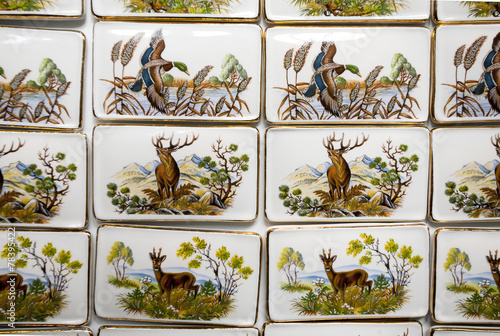 Wild animal motifs on handmade porcelain fridge magnets. Hunting photo