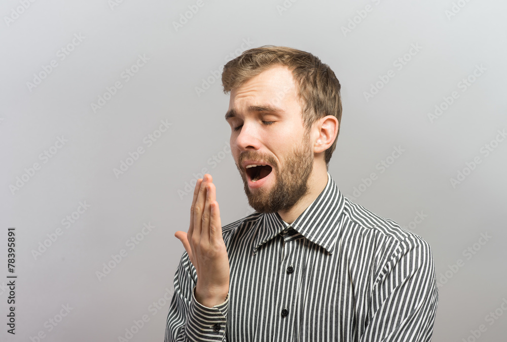 Handsome young businessman with hands behind head sleeping on wooden wall Handsome young businessman with hands behind head sleeping on wooden wall