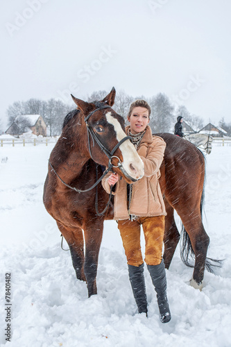 the girl next door with a horse in the winter on snow