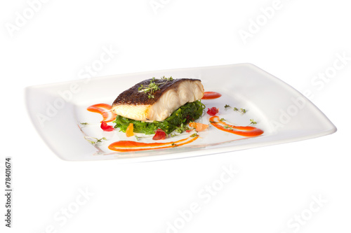 a piece of fried fish on white plate