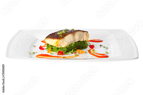 a piece of fried fish on white plate
