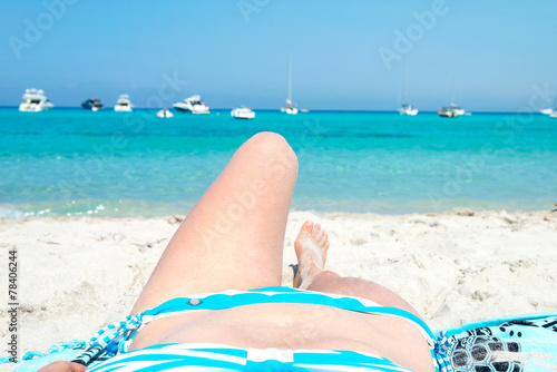 Woman sunbathing on the white beach of Saleccia Corsica, France © Matteo Gabrieli