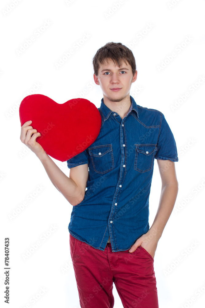 Handsome man holding a red heart on white background Handsome man holding a red heart on white background