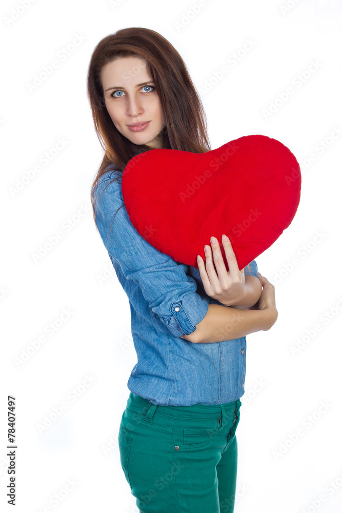 Brunette holding a red heart in hands on white background Brunette holding a red heart in hands on white background