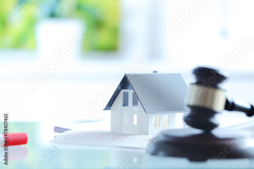 Conceptual White Little House on Top of Documents