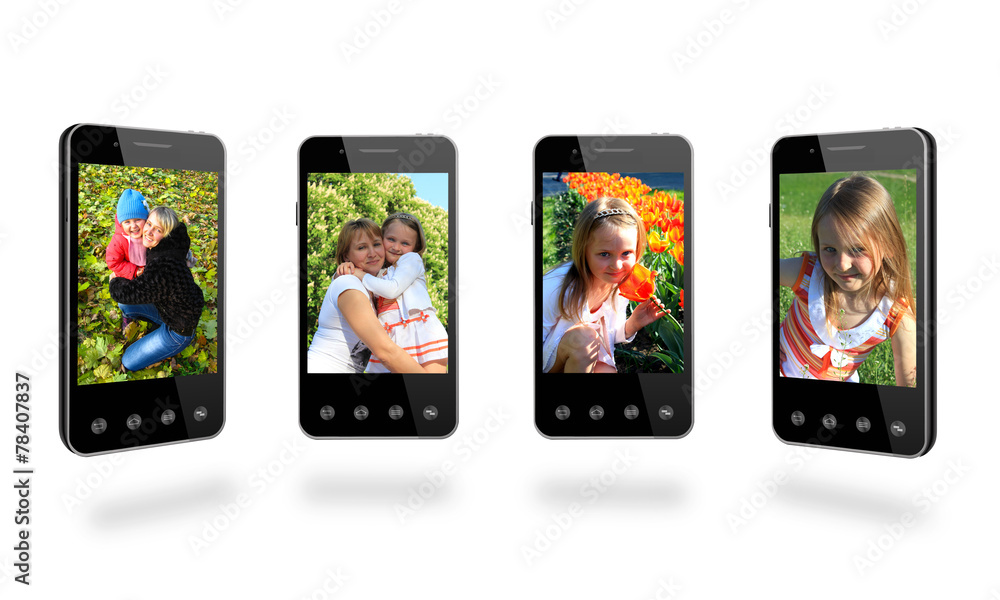 four smart-phones with colored images isolated on the white four smart-phones with colored images isolated on the white