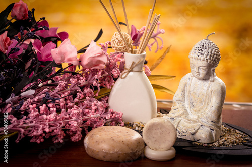 incense and buddha statue with flowers spa concept