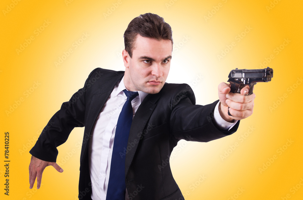 Businessman with gun isolated on white Businessman with gun isolated on white