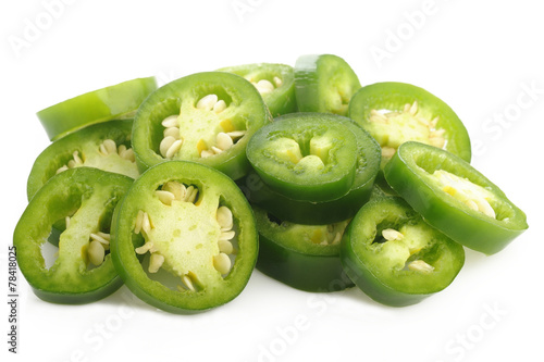sliced green jalapeno peppers on white background