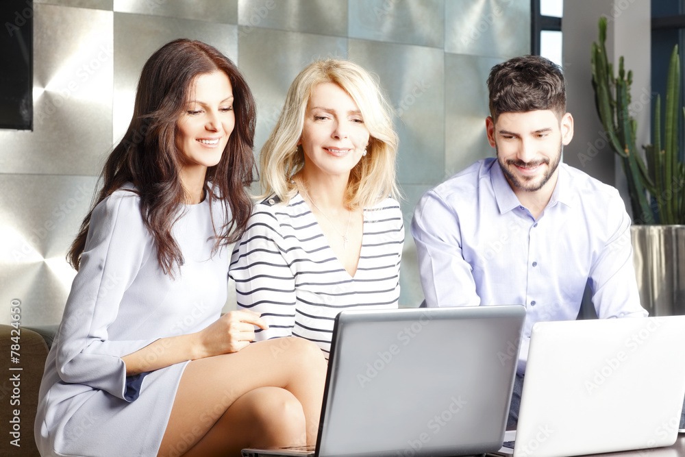 Business people sitting in front of laptop while Business people sitting in front of laptop while
