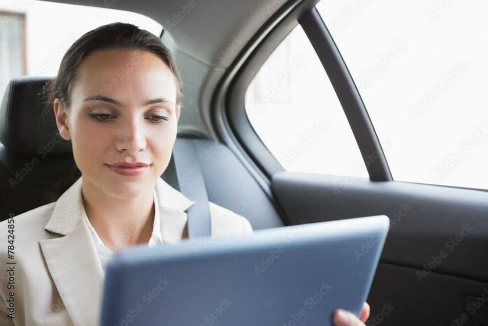 Pretty businesswoman using her tablet pc