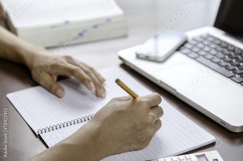 Image of woman taking note