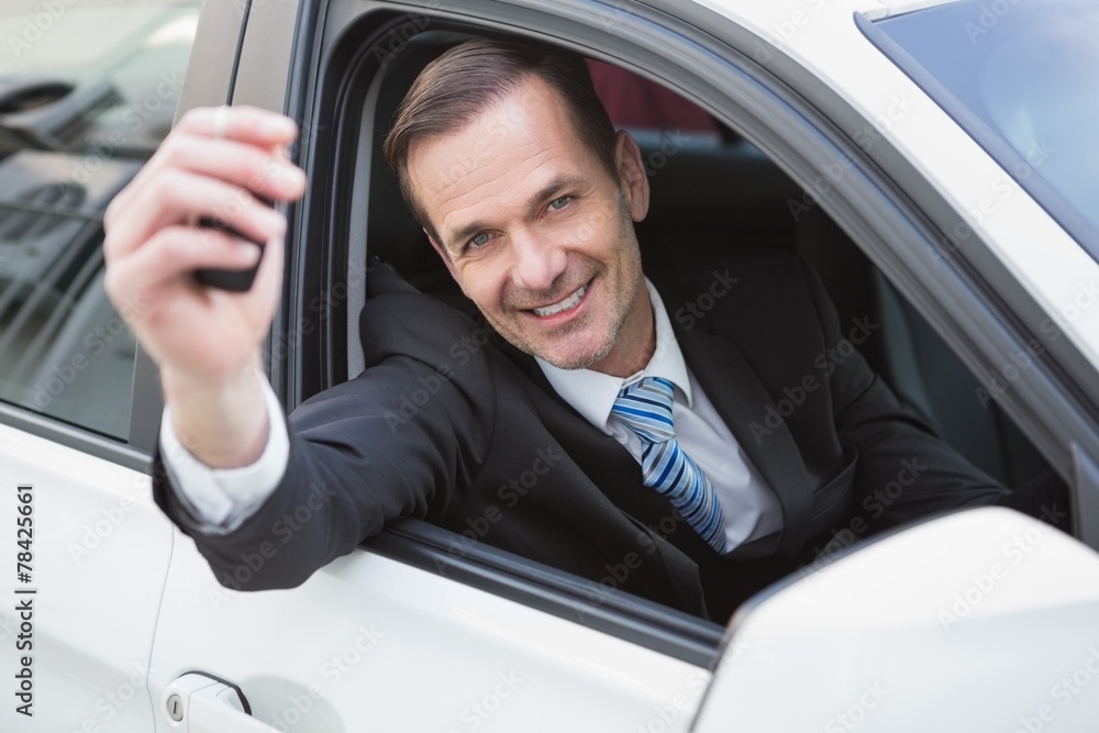 Businessman smiling and showing key Businessman smiling and showing key