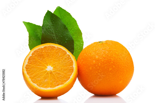 Whole and half orange  with leaves