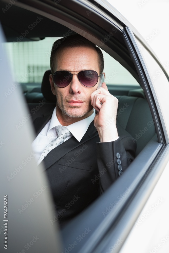 Businessman on the phone wearing sunglasses