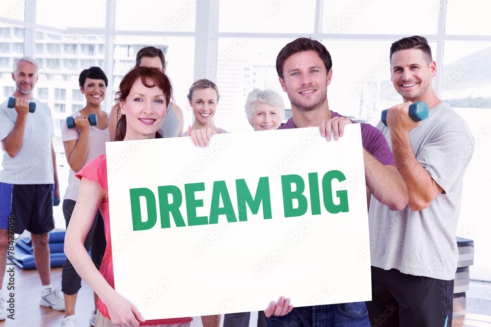 Composite image of couple holding a white sign Composite image of couple holding a white sign