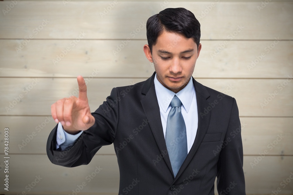Composite image of stern asian businessman pointing Composite image of stern asian businessman pointing