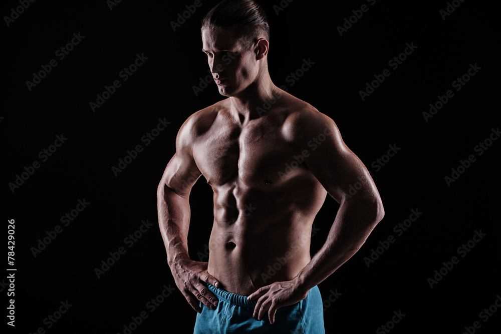 Fototapeta premium strong athletic man on black background