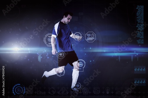 Composite image of football player in blue kicking © WavebreakmediaMicro
