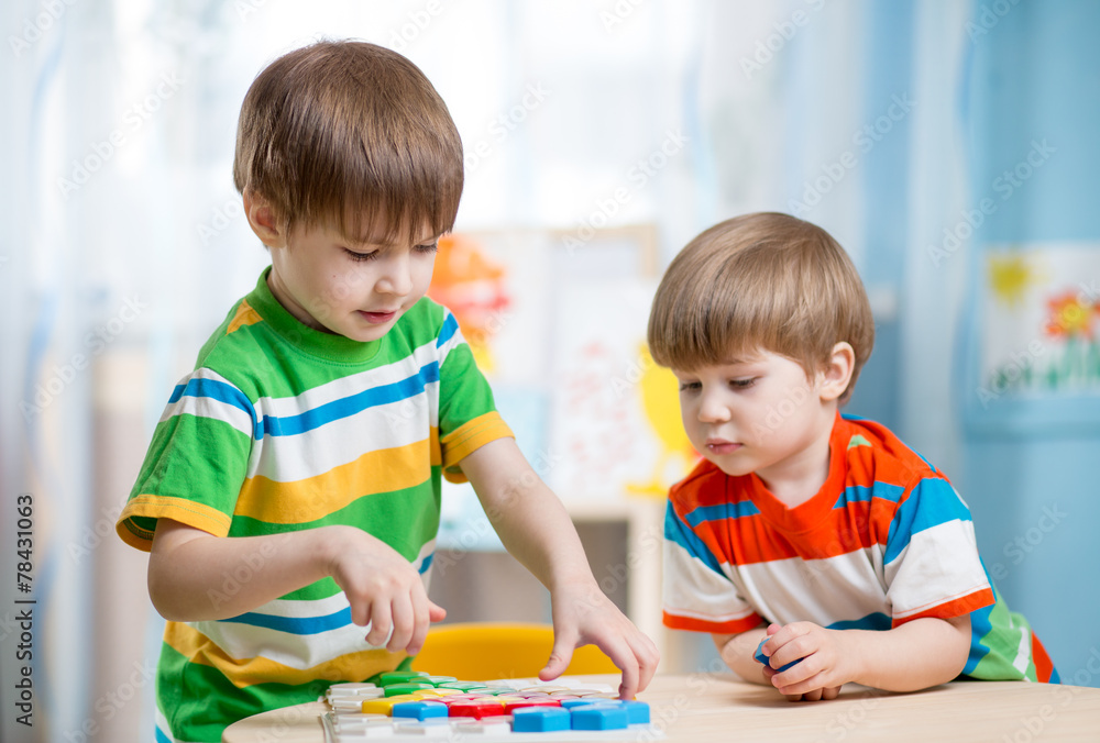 kids brothers play together at table kids brothers play together at table