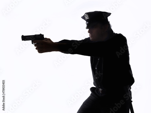Silhouette of a policeman with the handgun on white background